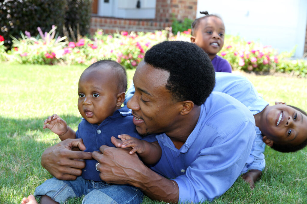 Father and sons playing