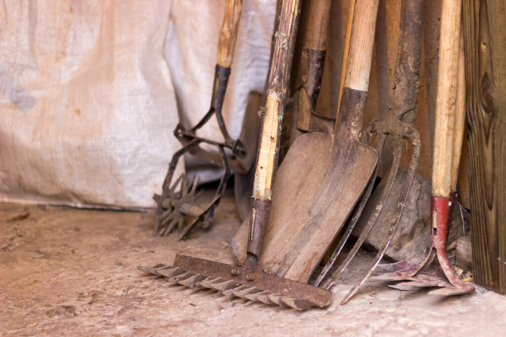 A row of dirty garden tools
