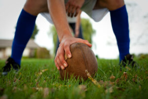 Playing with the old pigskin outside.