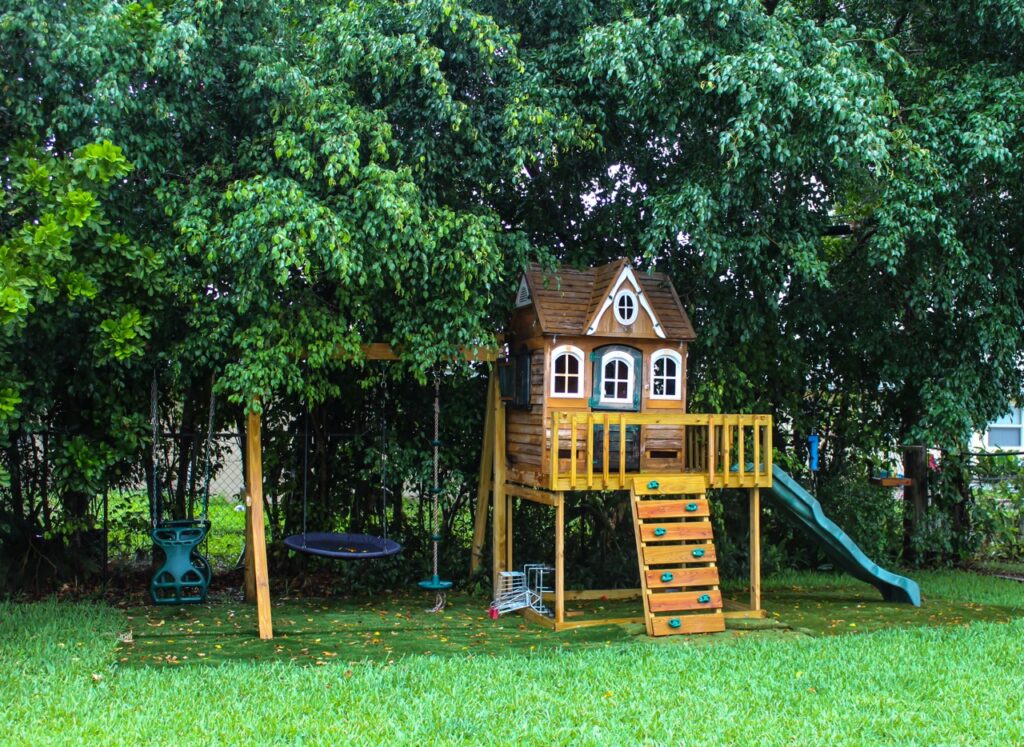 landscaped yard with trees and swing set
