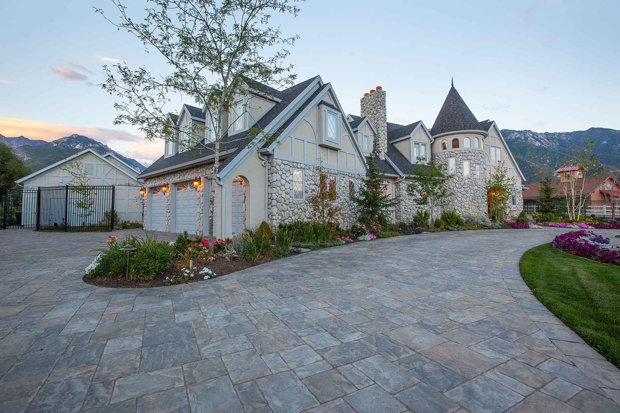 high end home with paver driveway