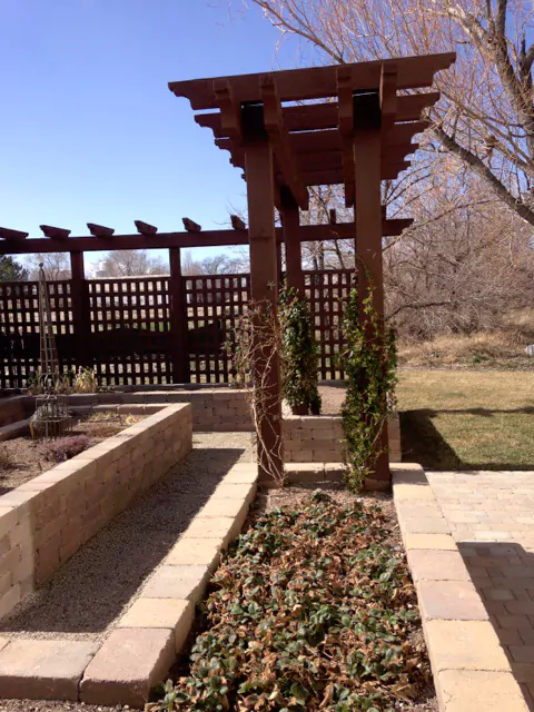 Wood pergola around garden boxes