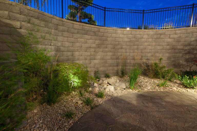 A residential retaining wall with a fence on the top