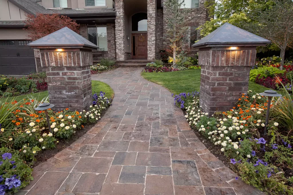 Paver walkway leads to the front door of a home