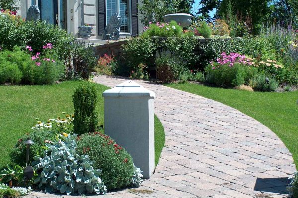 front sidewalk with pavers and beautiful landscaping