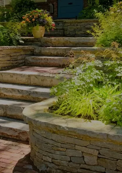 Stone retaining wall with a sitting bench and rock steps
