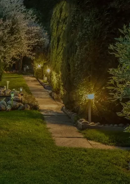 backyard sidewalk with garden lights along the walkway